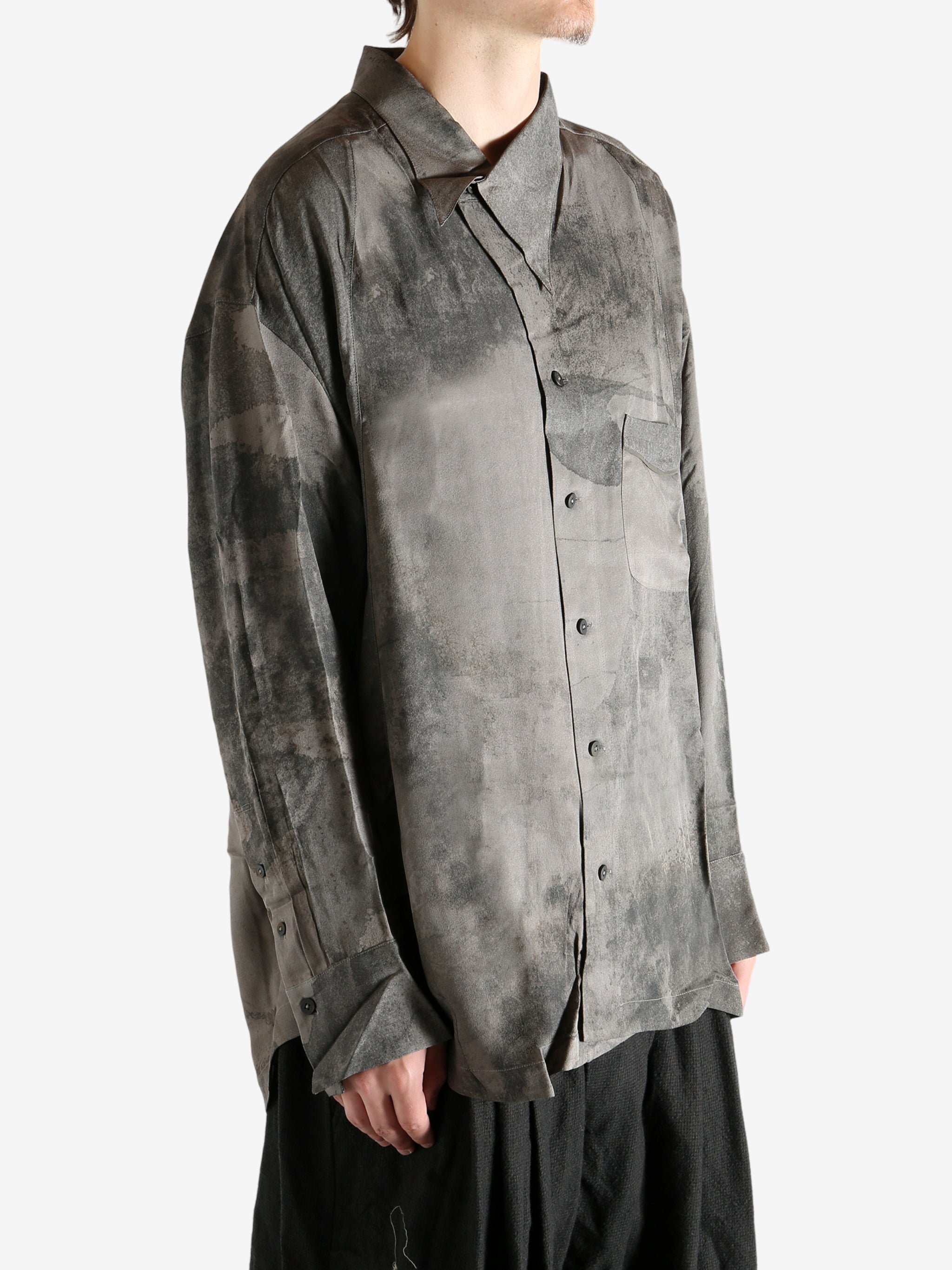 Grey shirt worn by a person, showing the shirt's it