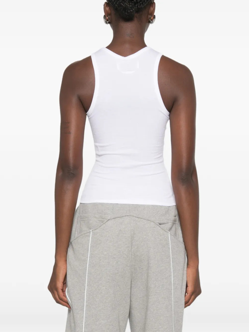 White top worn by a person, showing the top fit