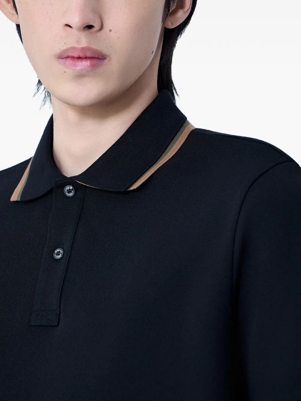 close up of black shirts, showing texture of the cotton fabric