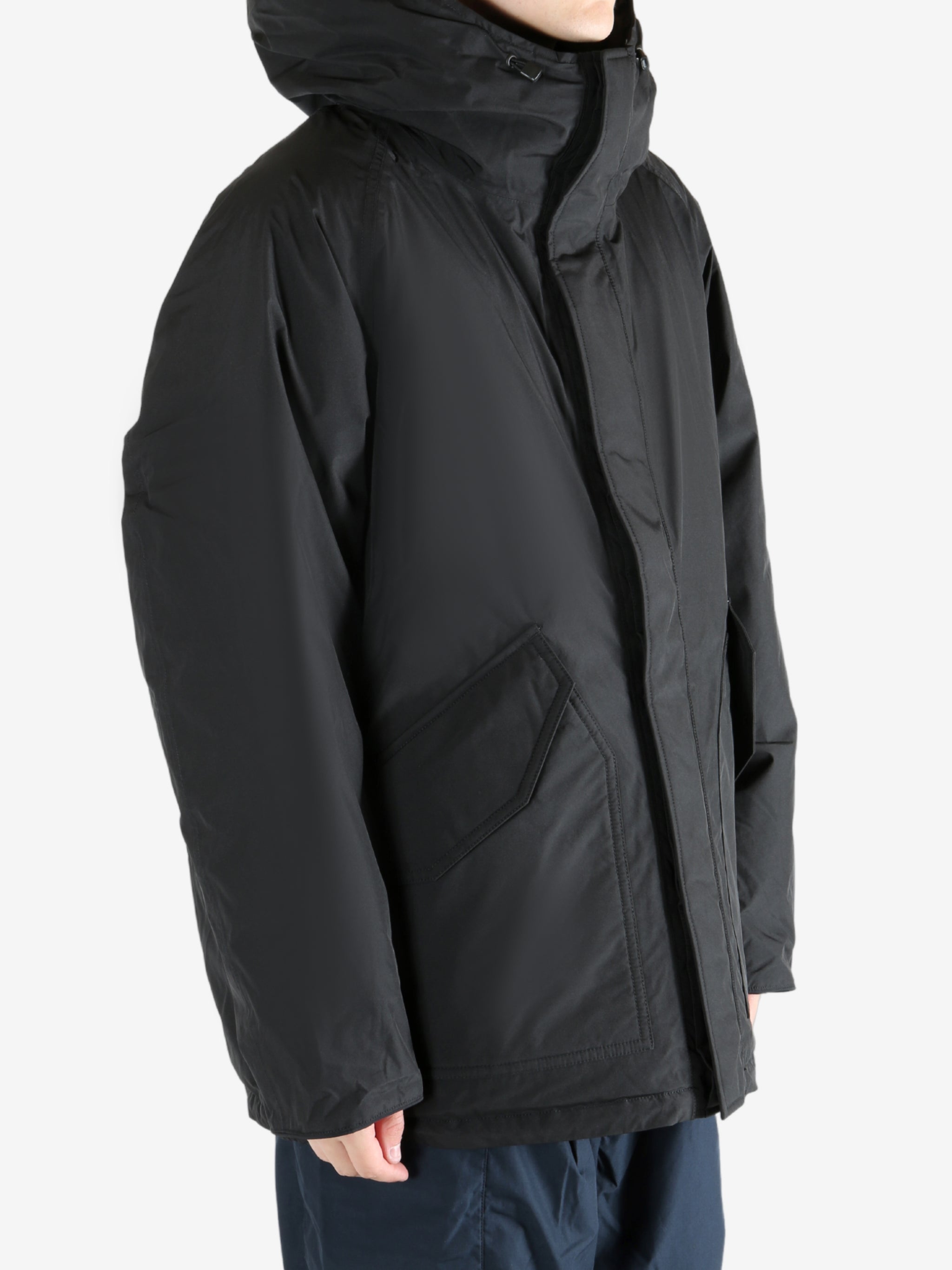 Black coat worn by a person,showing the coat fit