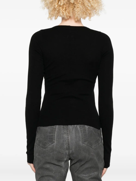 Black shirt worn by a person, showing the shirt fit