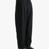Black pants worn by a person, showing the pants fit