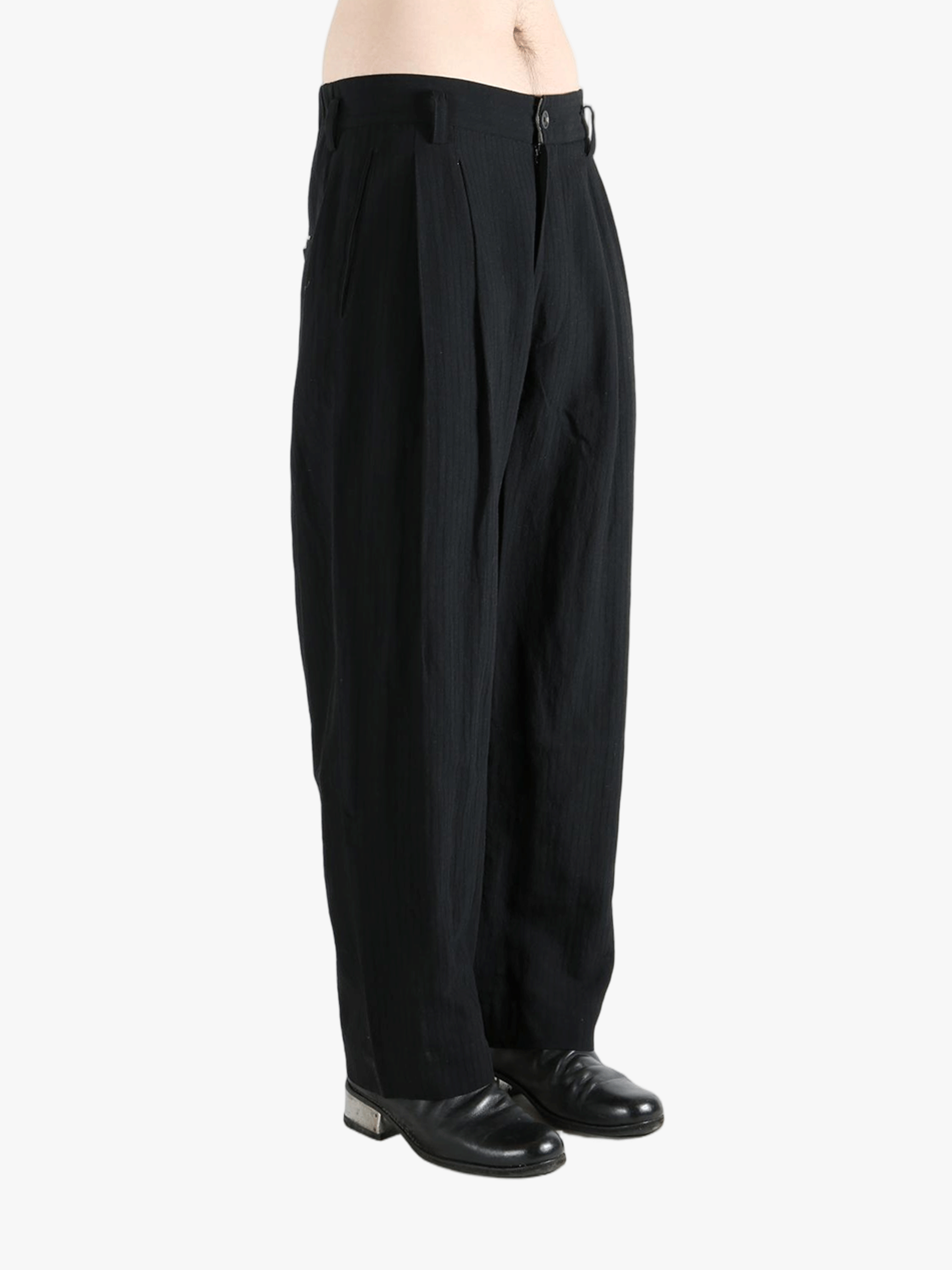Black pants worn by a person, showing the pants fit