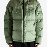 Green jacket worn by a person, showing the jacket's fit