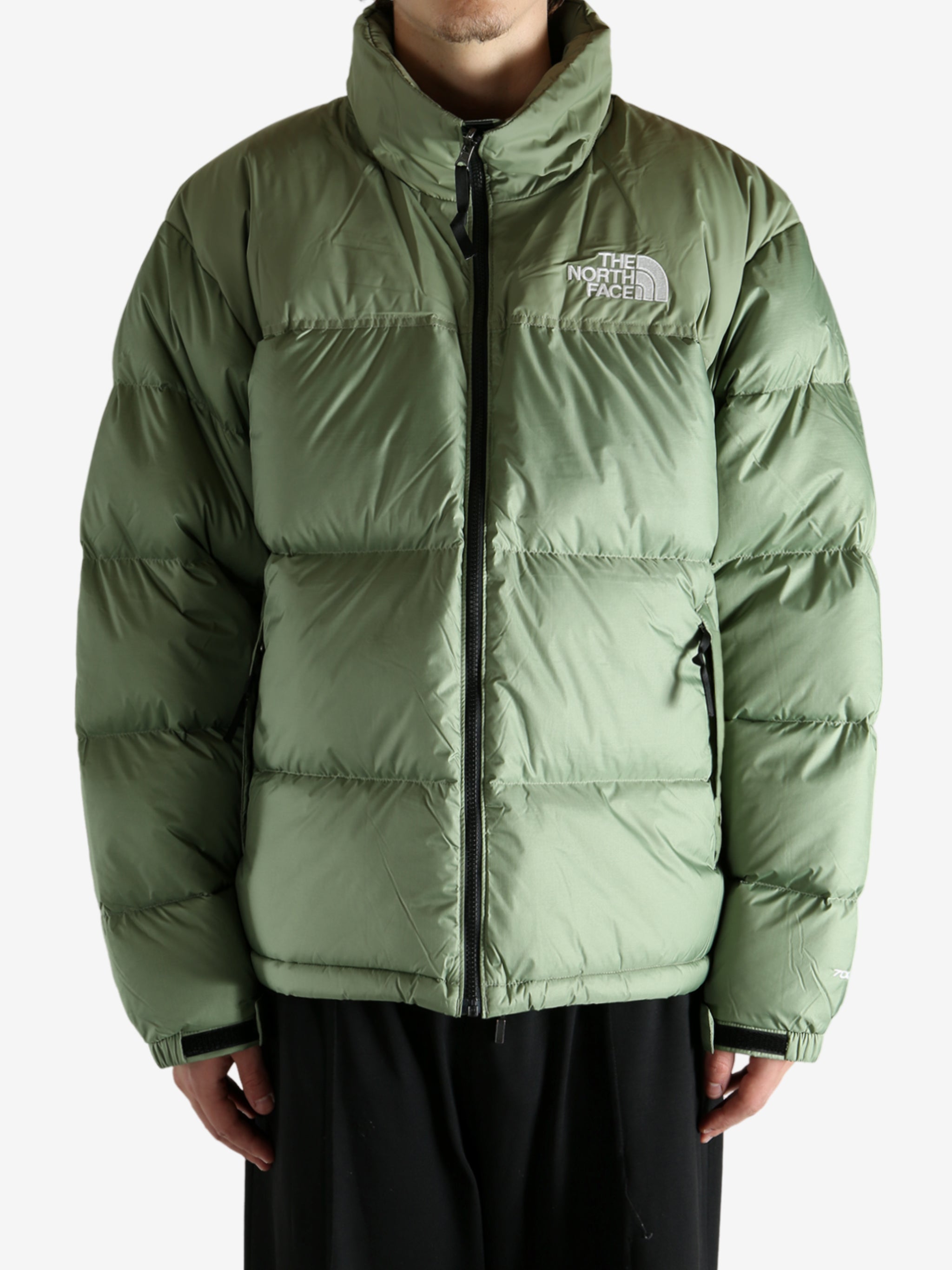 Green jacket worn by a person, showing the jacket's fit