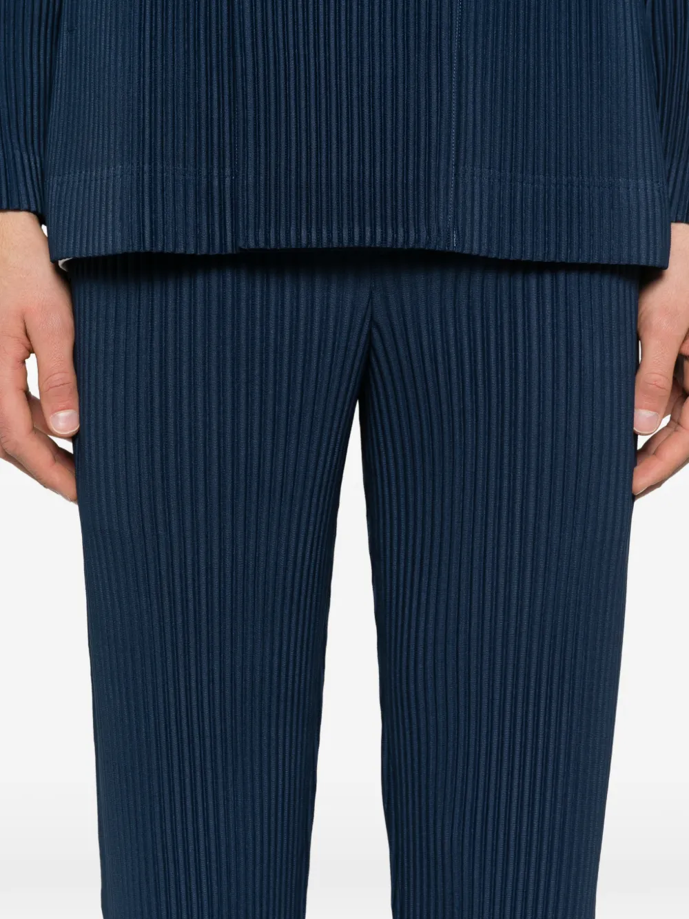 close up of blue pants, showing texture of the polyester fabric
