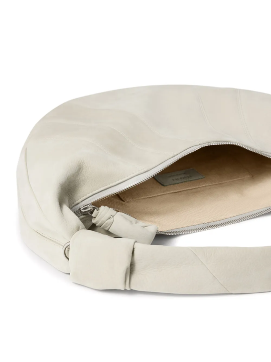 Close up of white bag, showing texture of the calf leather fabric