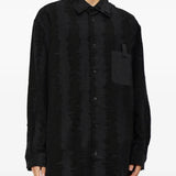 Black shirt worn by a person, showing the shirt fit