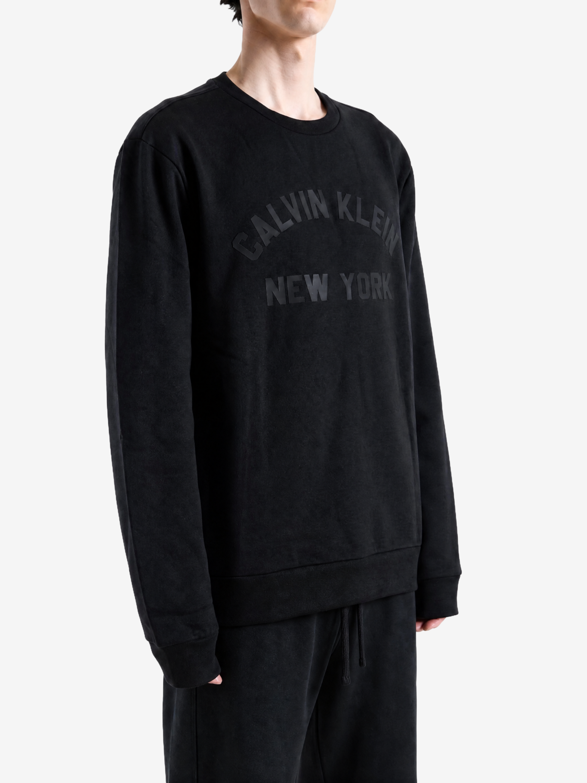 Black hoodie worn by a person, showing the hoodie fit