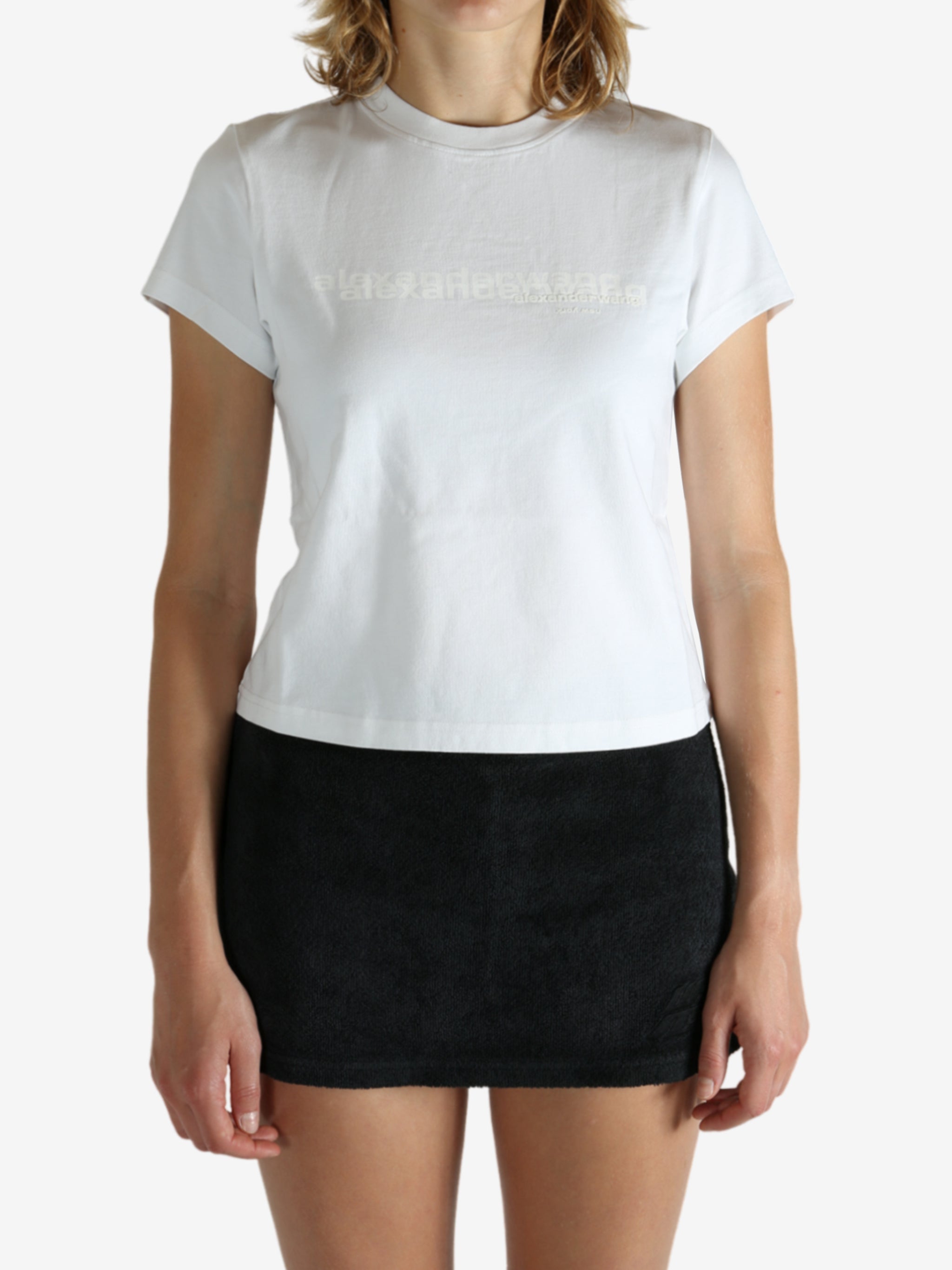 White t-shirt worn by a person, showing the shirt's fit