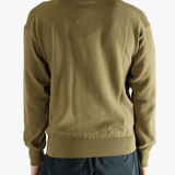 Green sweater worn by a person, showing the sweater fit