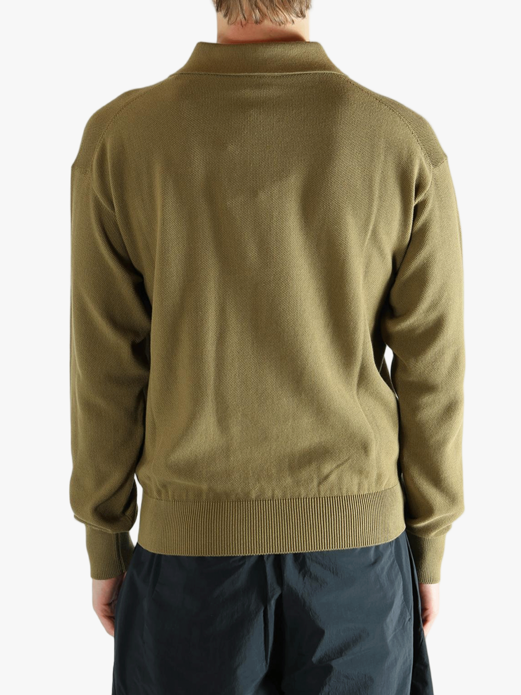 Green sweater worn by a person, showing the sweater fit
