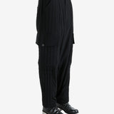 Black pants worn by a person, showing the pants' fit