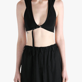 Black tops worn by a person, showing the tops fit