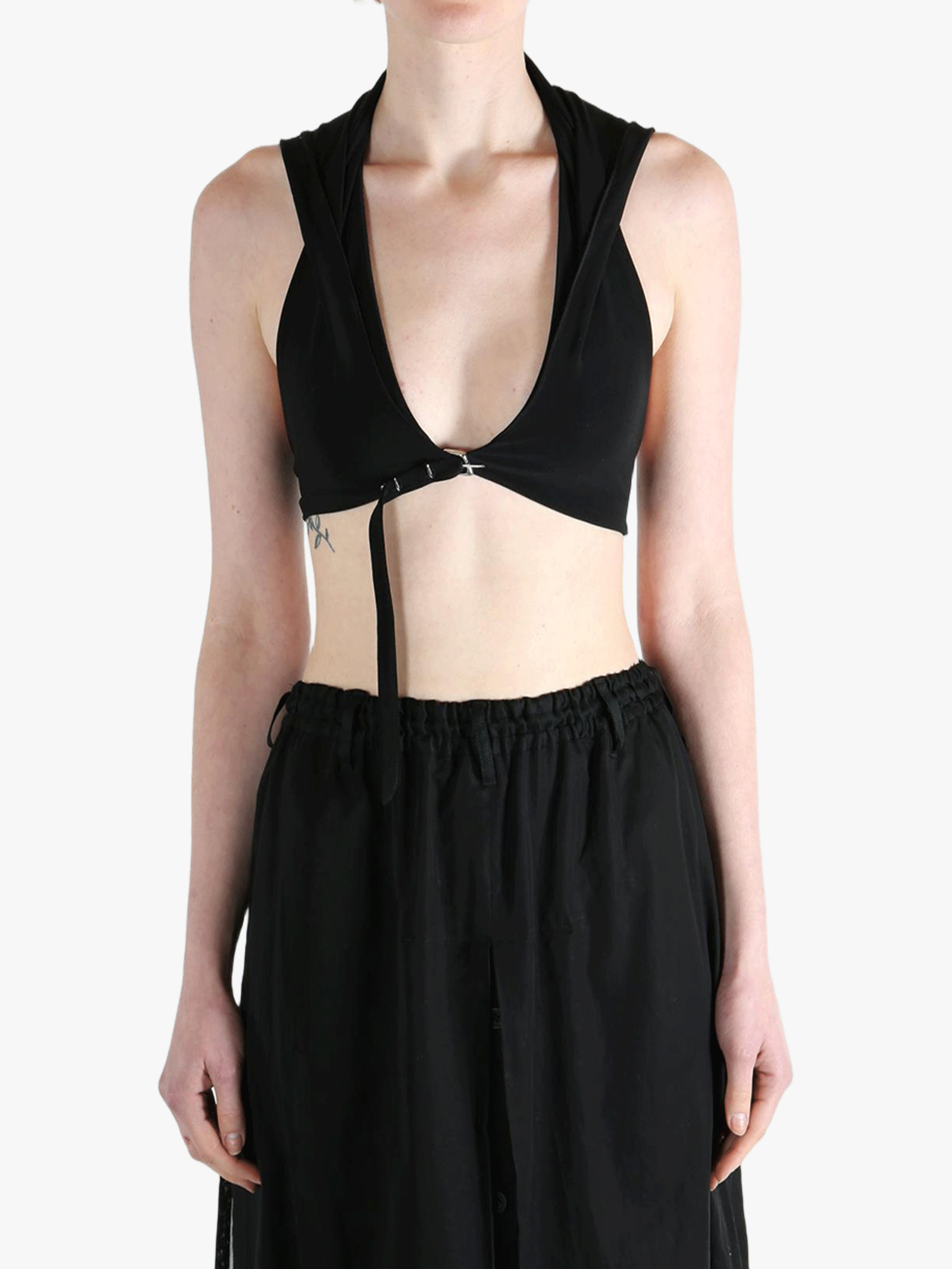 Black tops worn by a person, showing the tops fit