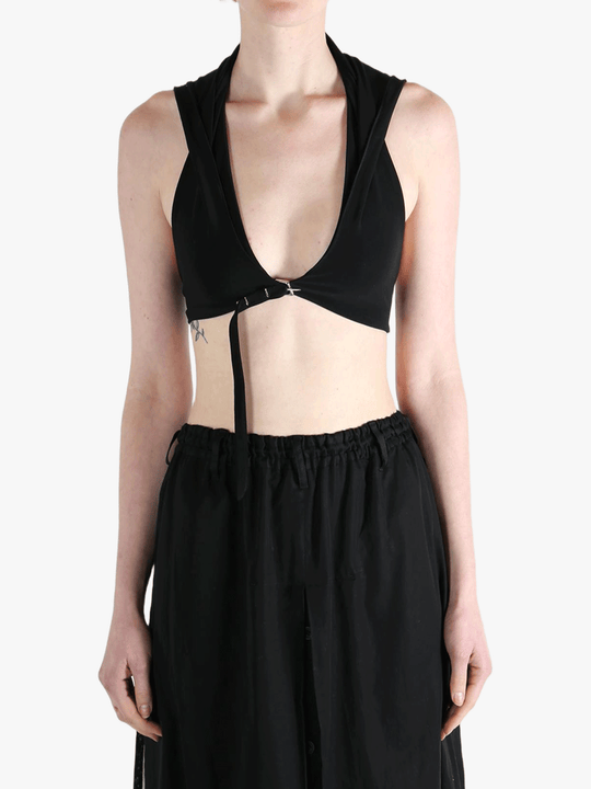 Black tops worn by a person, showing the tops fit