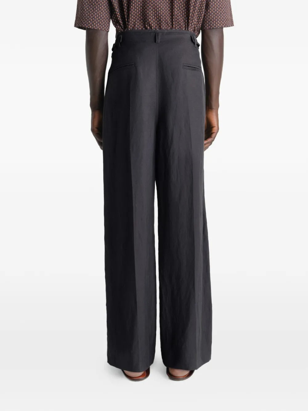 Black pants worn by a person, showing the pants fit