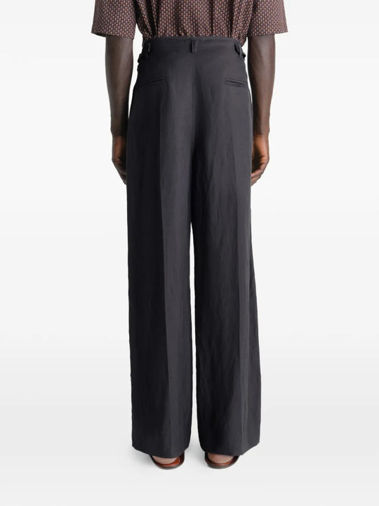 Black pants worn by a person, showing the pants fit