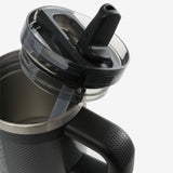 Close up of black tumbler, showing texture of the lid and straw