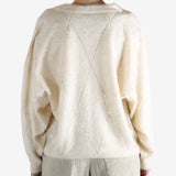 Tan knitwears worn by a person, showing the knitwears fit