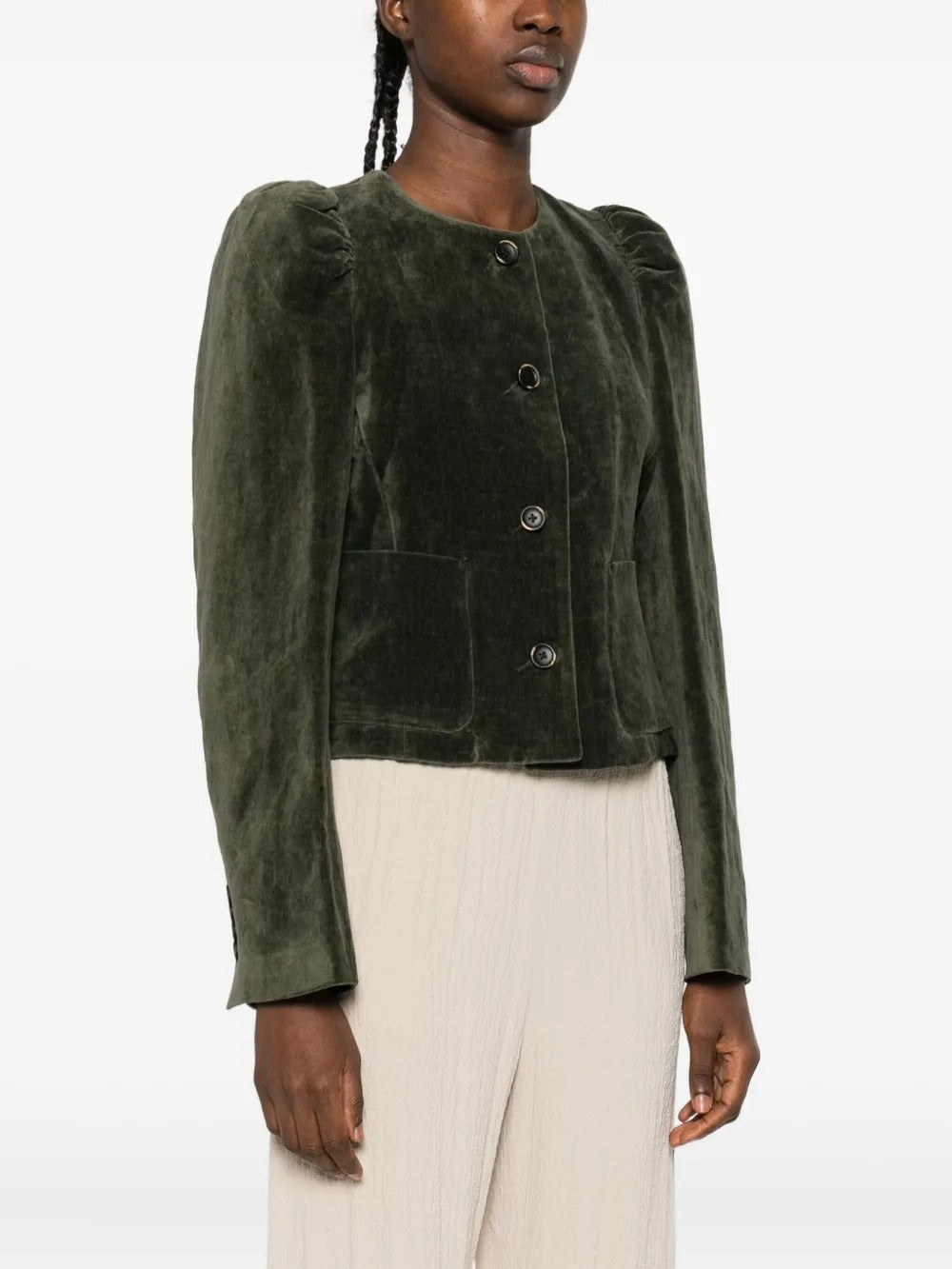 Green jacket worn by a person, showing the jacket’s fit