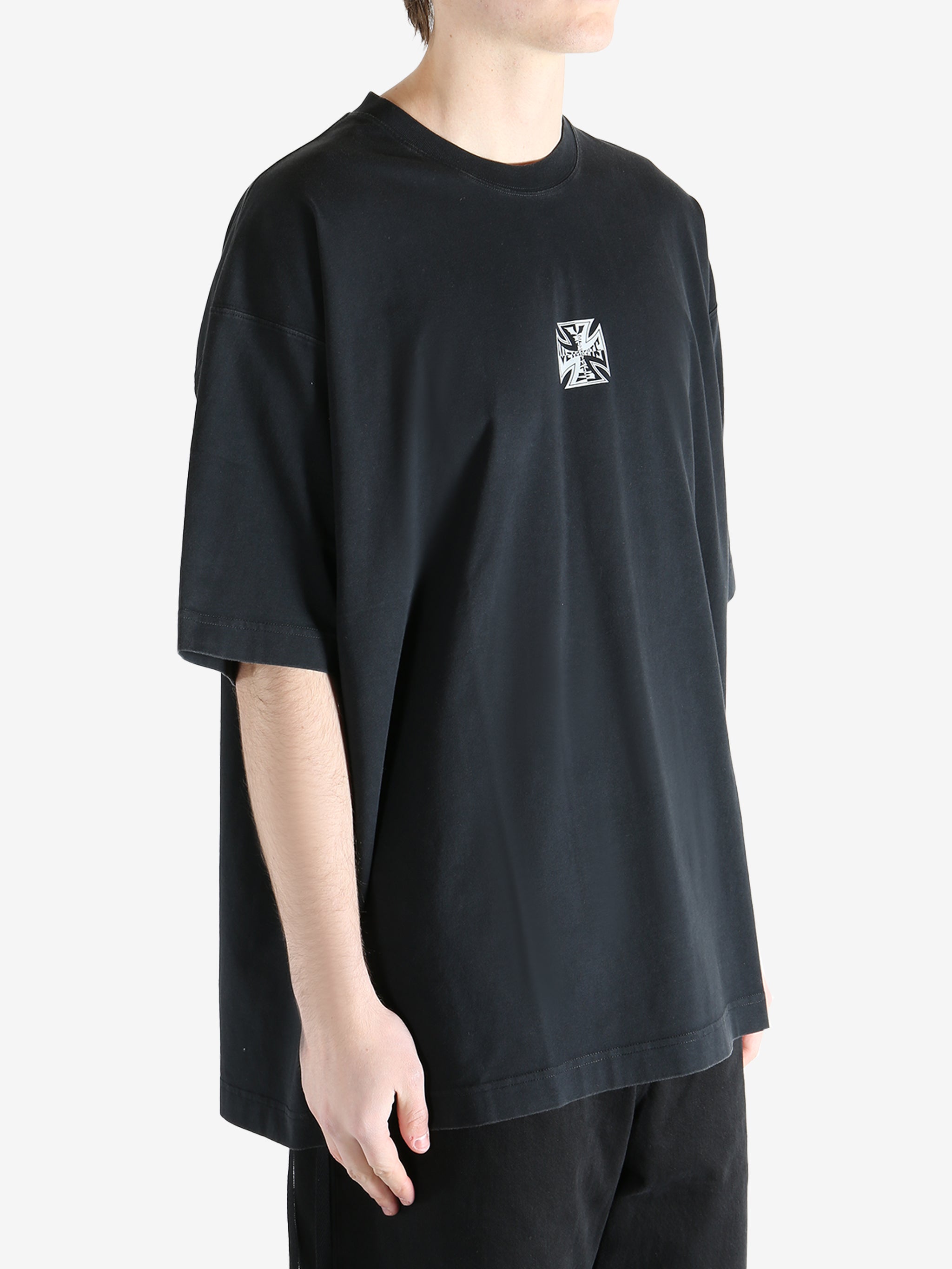 Black t-shirt worn by a person, showing the t-shirt's fit