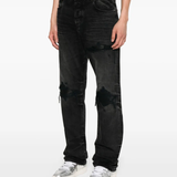 Black jeans worn by a person, showing the jeans' fit