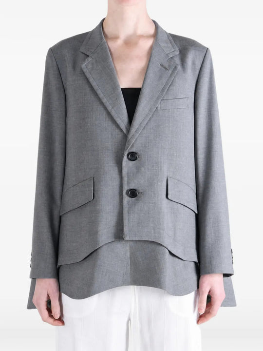 Grey jacket worn by a person, showing the jacket fit