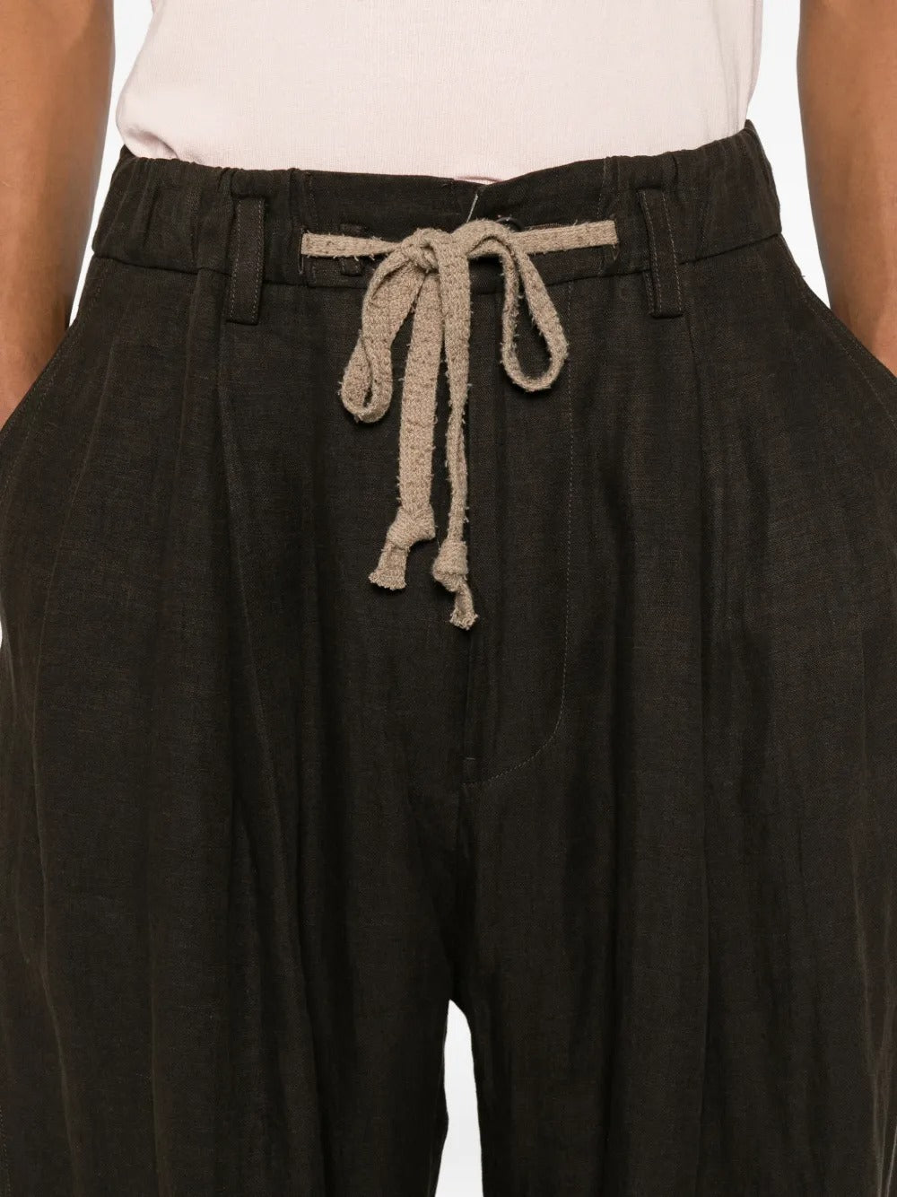 Black pants worn by a person, showing the pants fit