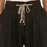 Black pants worn by a person, showing the pants fit