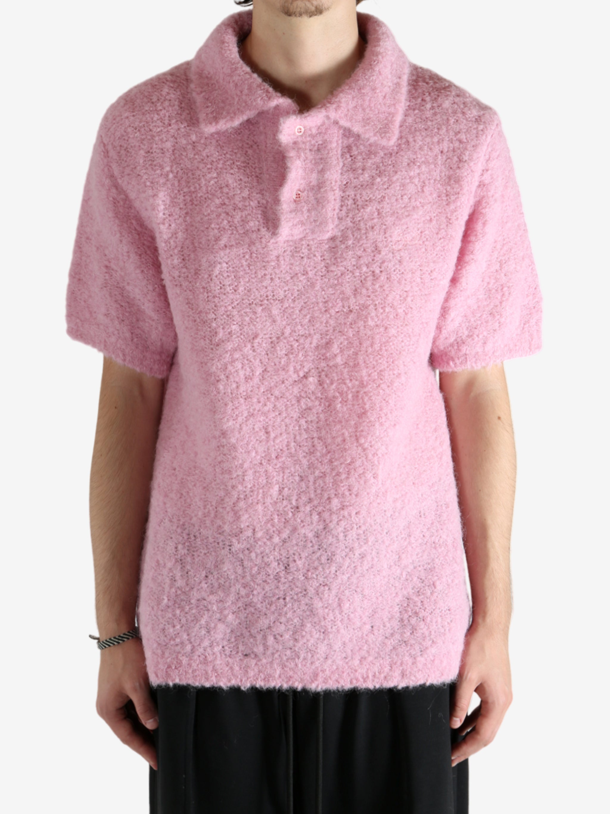 Pink knitwear worn by a person, showing the knitwear's fit