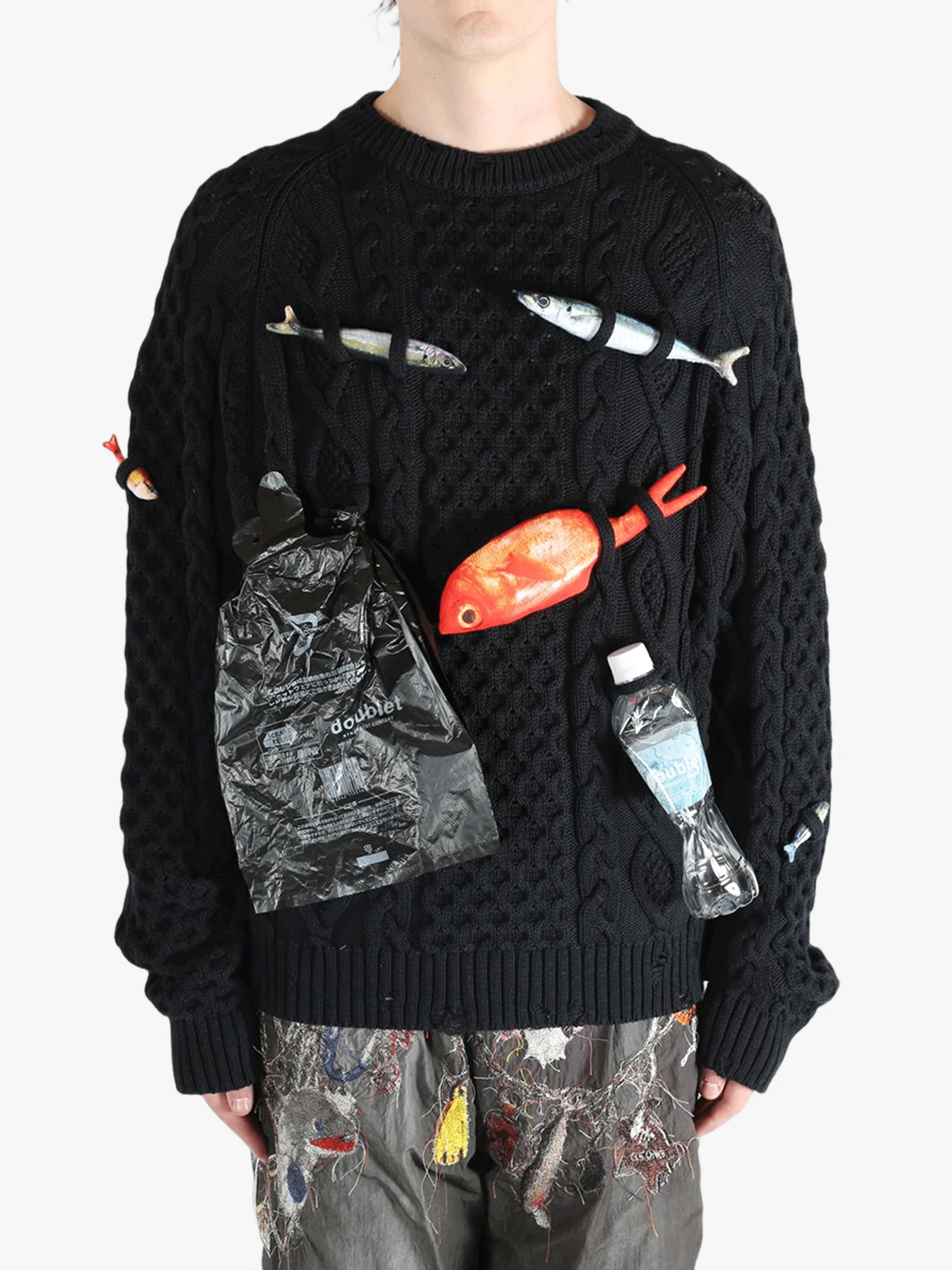 Black knitwear worn by a person, showing the knitwear's fit