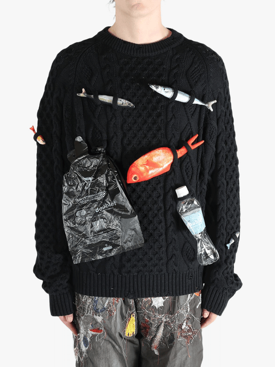 Black knitwear worn by a person, showing the knitwear's fit