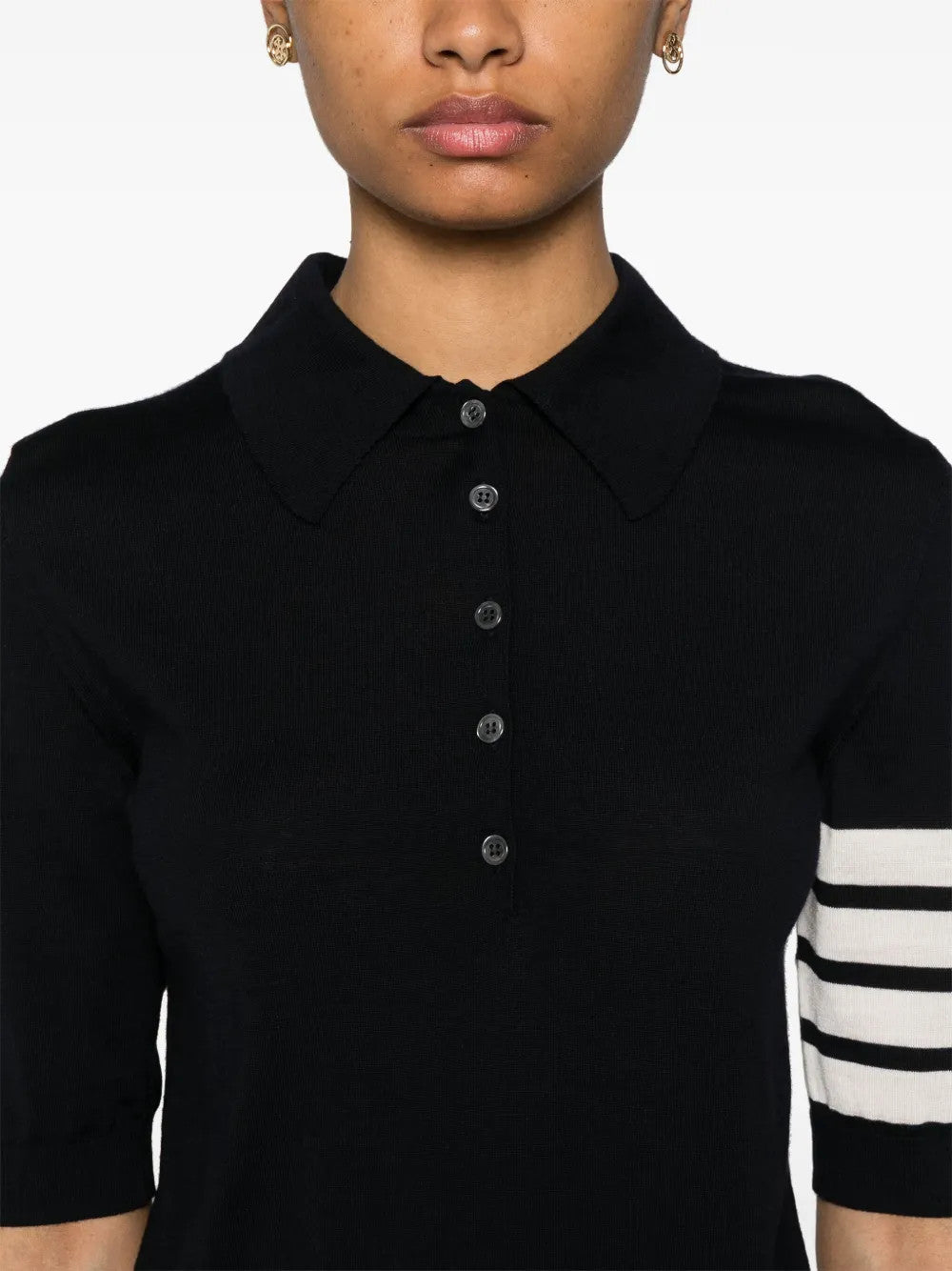 Black shirt worn by a person, showing the shirt fit