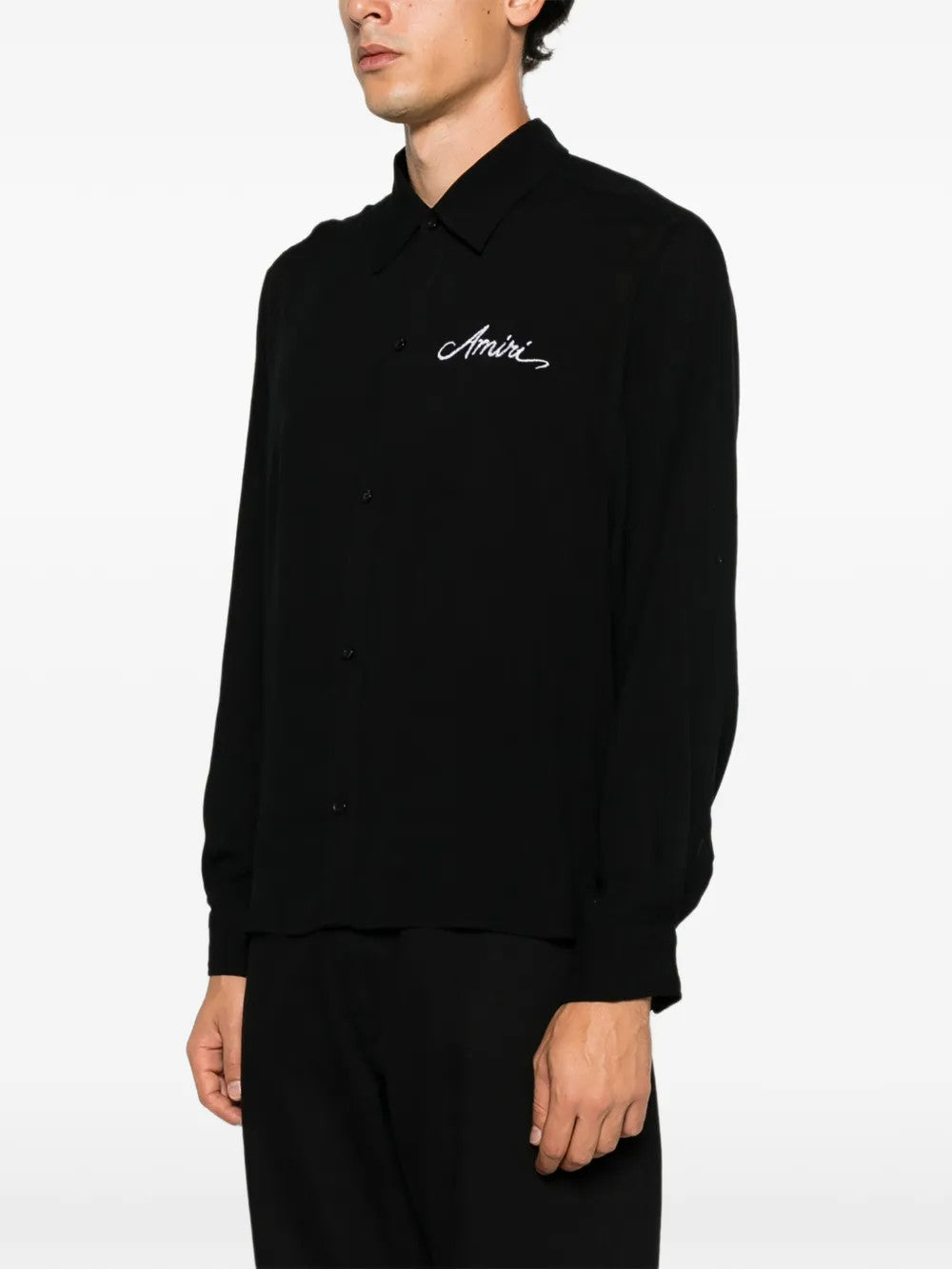 Black shirt worn by a person, showing the shirt fit