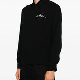 Black shirt worn by a person, showing the shirt fit