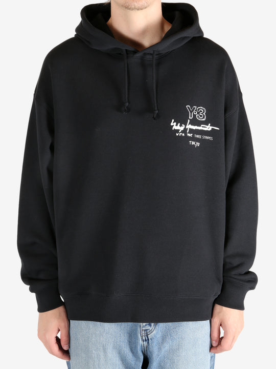 Black hoodie worn by a person, showing the hoodie's fit