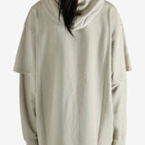 Tan hoodie worn by a person, showing the hoodie's fit
