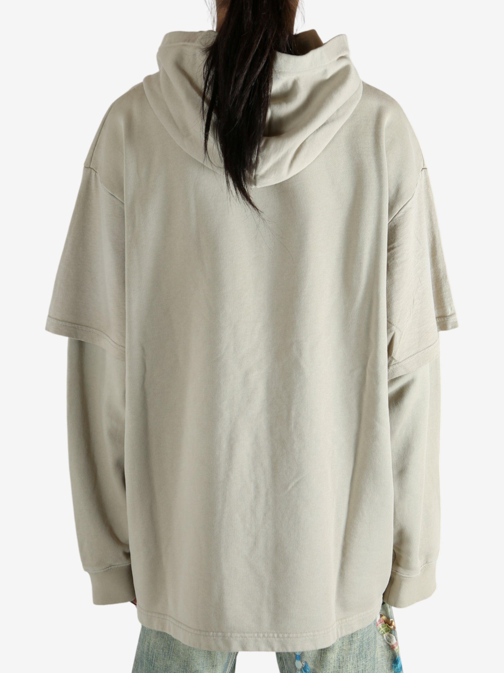 Tan hoodie worn by a person, showing the hoodie's fit