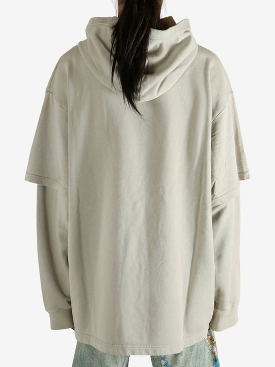 Tan hoodie worn by a person, showing the hoodie's fit