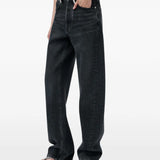 Black jeans worn by a person, showing the jeans fit
