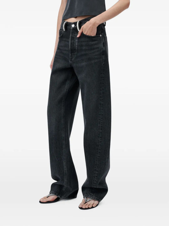 Black jeans worn by a person, showing the jeans fit