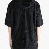 Black shirt worn by a person, showing the shirt's fit