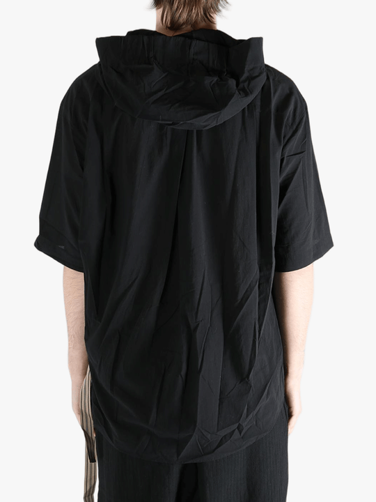 Black shirt worn by a person, showing the shirt's fit