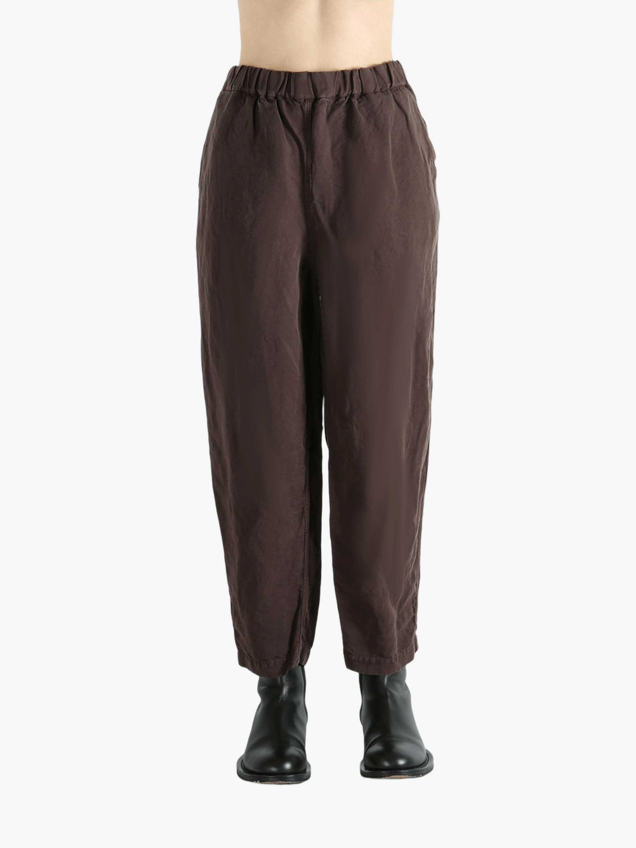 Brown pants worn by a person,showing the pants fit