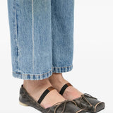 Black flat worn by a person, showing the flat's fit