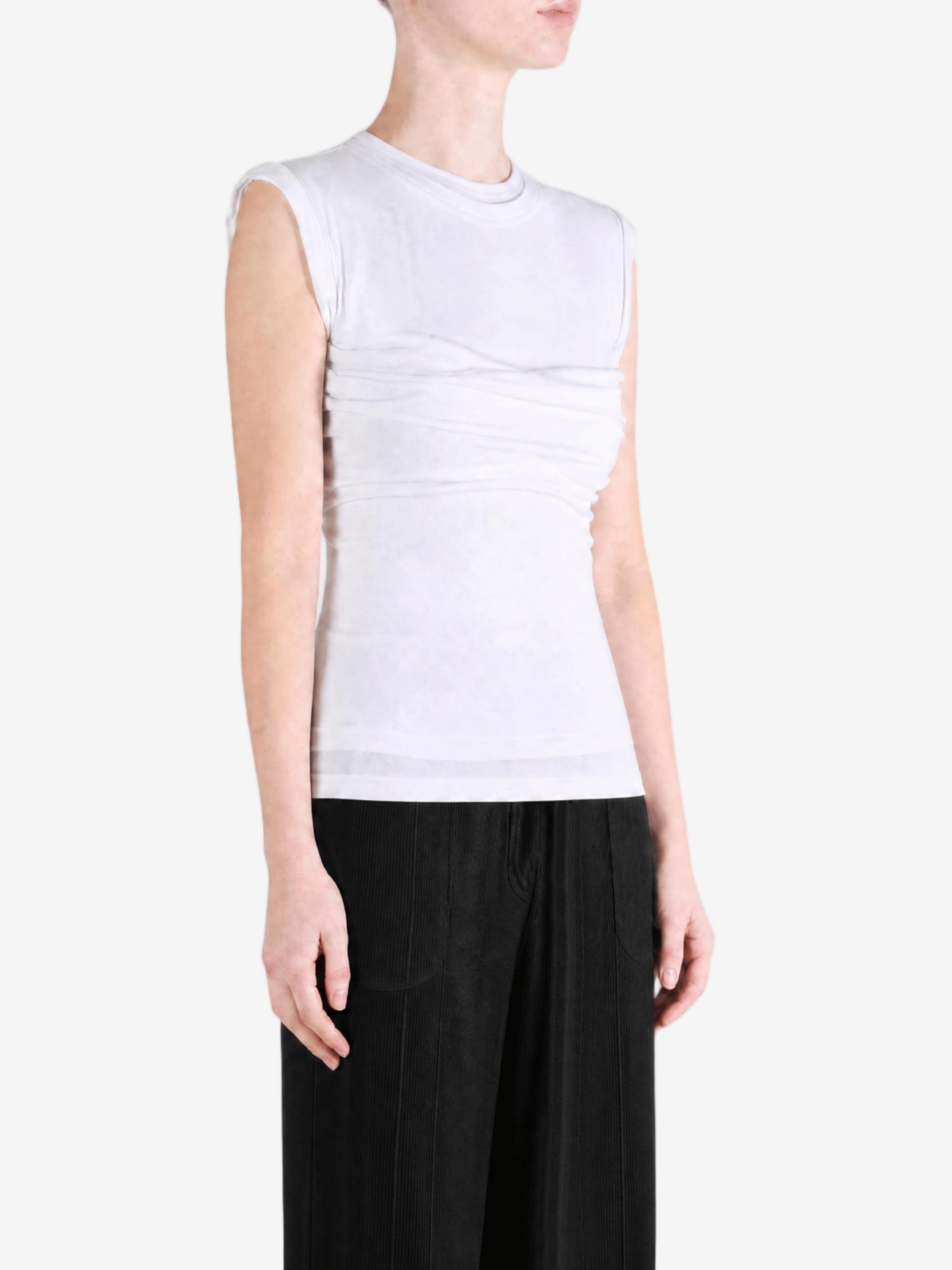 White top worn by a person, showing the top fit