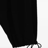 Close up of black pant, showing texture of the triacetate fabric