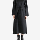 Black dresses worn by a person, showing the dresses fit