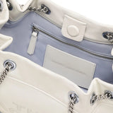 Close up of the white bag, showing texture of the leather fabric